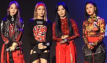 Image of Mamamoo members dressed in black and red