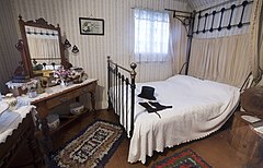 A 19th century bedroom with a top hat over the bed. Victorian Village, Museum of Transport and Technology (MOTAT) , Auckland, New Zealand.