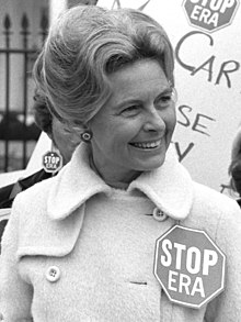 American conservative activist and lawyer Phyllis Schlafly (1924-2016), pictured in 1977. Activist Phyllis Schafly wearing a "Stop ERA" badge, demonstrating with other women against the Equal Rights Amendment in front of the White House, Washington, D.C. (42219314092) (cropped 2).jpg