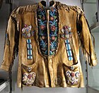Man's hide jacket. The floral designs' stems feature "thorny" beadwork, typical of the Subarctic, Museum of Anthropology at UBC