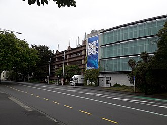 Thomas Building Complex - Buildings 110 (left) & 110N (right) - of the University of Auckland, which houses the School of Biological Sciences (SBS) and Maurice Wilkins Centre for Molecular Biodiscovery. Note the poster on the building features an unusual University of Auckland logo. B110 110N Thomas Building Complex The University of Auckland.jpg