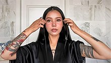 Poarch shows her Tik-Tok makeup routine for Vogue Taiwan in 2021.