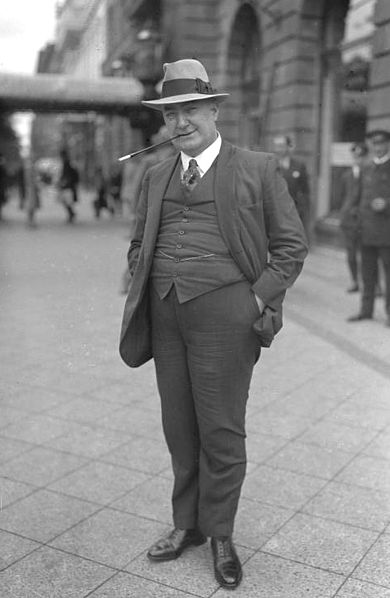 Edgar Wallace with trademark trilby hat and cigarette holder at the height of his success in 1928