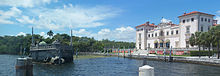 Vizcaya Mansion (on right) and its stone barge (on left) Coco Grove FL Vizcaya mansion and barge pano01.jpg