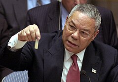 US Secretary of State Colin Powell, holding up a model vial of alleged weaponized anthrax during a February 2003 presentation at the United Nations. Colin Powell anthrax vial. 5 Feb 2003 at the UN.jpg