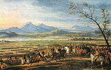 kleurschilderij van een generaal te paard, omringd door zijn staf, kijkend naar infanteriepleinen die zich over de vlakte ontwikkelen.  In de verte signaleert een rookgordijn de vijandelijke artillerie.