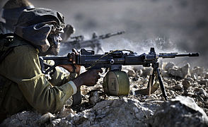 IDF infantry soldier fires the Israeli Military Industries Negev machine gun