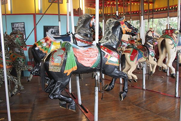 Note the slots in the floor that allow the horses to tilt while the carousel is in motion, an unusual feature.