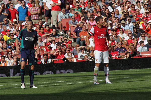 O'Shea (left) in action for Sunderland against Arsenal in 2012