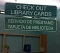 A library sign in English with Spanish below, in Texas. The city has many Spanish speakers moving in, so the public library has added Spanish books and Spanish signs.