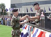 Lt. Gen. Lawson W. Magruder III accepts a shell casing from a U.S. Army military police honor guard officer at his retirement ceremony, 27 February 2003. Lt. Gen. Lawson W. Magruder III retirement ceremony DA-SD-03-07328.jpg