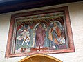 Freska pozdravlja romarje ob vhodu v cerkev;