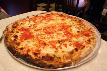 A cooked pizza served at a New York pizzeria