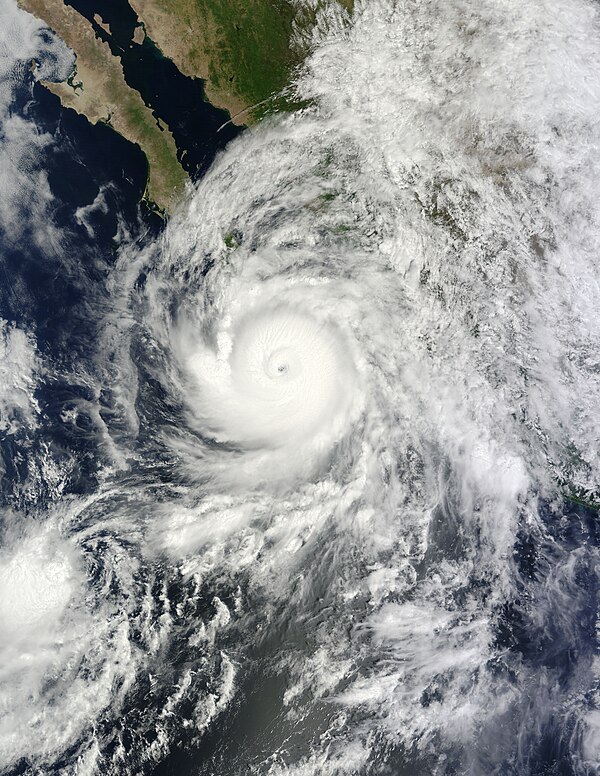 Odile shortly after peak intensity on September 14, with Tropical Depression Sixteen-E to its southwest