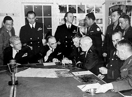 Buckner (sitting, 3rd right) with Vice Admiral Thomas C. Kinkaid (sitting, 2nd left) during the Aleutian Islands Campaign
