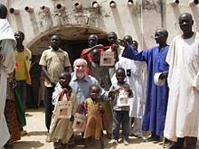 Two Senegalese kaftans being worn in Cameroon, right. Richard W. Nelson at lamidat of Marou.JPG