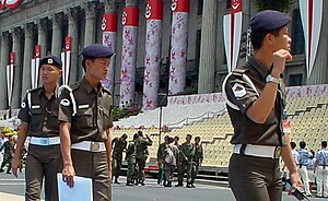 Two corporals (left) and a first sergeant (right) from the Singapore Armed Forces Provost Unit providing security cover for the 2000 National Day Parade at the Padang, Singapore. SAFPU NDP'00 02 (cropped).jpg