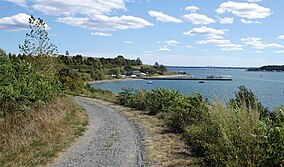 Path curves to left toward visitor center and pier in the distance.