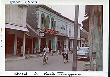 Street in Kuala Terengganu in June 1961 with a Chinese shop on the background.