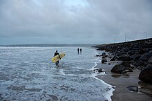 Surfers getting ready to catch some waves at Lahinch.