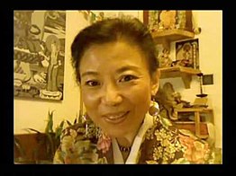 Woeser in her Beijing apartment in 2009 in front of her Tibetan Buddhist altar Tsering Woeser.jpg