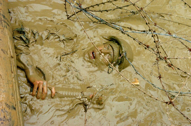 File:US Navy 050225-N-9712C-006 Journalist 2nd Class Barbera Silkwood, a Seabee assigned to Naval Mobile Construction Battalion Four Zero (NMCB-40), emerges from muddy water.jpg