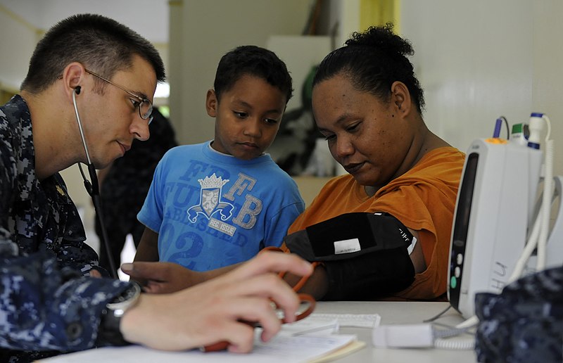 File:US Navy 100727-N-7280V-389 Ensign Neil Petersen Shawn takes vitals from a Palauan woman as her son watches at the Southern Community Health Center.jpg