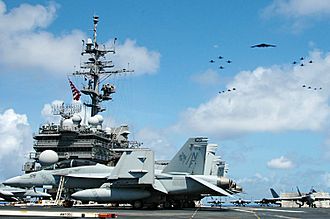 USS Kitty Hawk (CV-63) during the exercise, with fighter and bomber planes flying overhead Valiant Shield - US Kitty Hawk kicks off operations.jpg