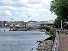 The Thames Path interrupted by Convoys Wharf View of Convoys Wharf from the Thames Path.jpg