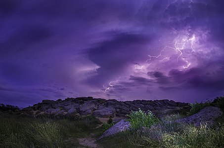 Nature site Kamyana Mohyla in Zaporizhia Oblast, Ukraine.The site encompasses a group of isolated blocks of sandstone, up to twelve meters in height, scattered around an area of some 3,000 square meters. Site is pictured inder lightning in May.