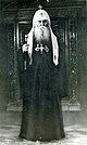 Патриарх Сергий в полный рост в патриаршем куколе, с посохом в правой руке.jpg