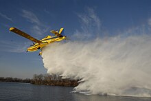 A Fire Boss on floats dropping its load