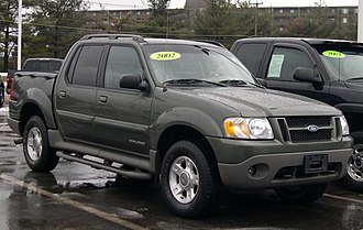 A 2002 Ford Explorer Sport Trac with a black nerf bar hanging from the body on the bottom left. 2002 Ford Explorer Sport Trac.jpg