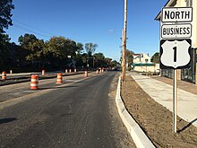 A road in a suburban area with a sign reading Mercer County 616 right