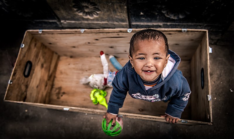 File:A little girl with her plastic toy.jpg