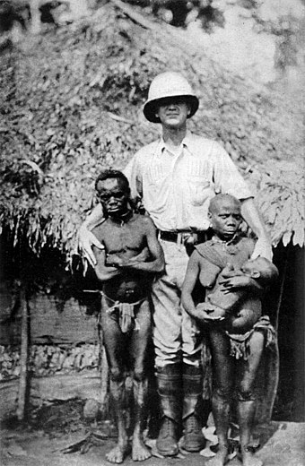 Pygmies and a European. Some pygmies would be exposed in human zoos, such as Ota Benga displayed by eugenicist Madison Grant in the Bronx Zoo.