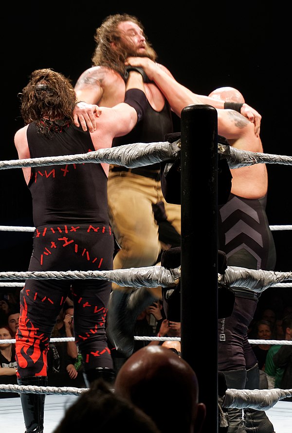 Big Show and Kane performing a double chokeslam on Braun Strowman