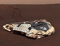 The unfolded, empty lander for the rover Opportunity after completing the "hole-in-one" landing inside Eagle Crater. Challenger Memorial Station At Meridiani Planum.jpg