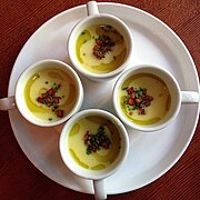 Cups of corn chowder with bacon, potato, olive oil and chives