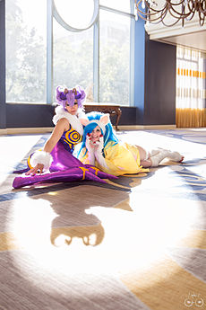 A photograph of two women cosplaying as Felicia and another Darkstalkers character, Q-Bee.