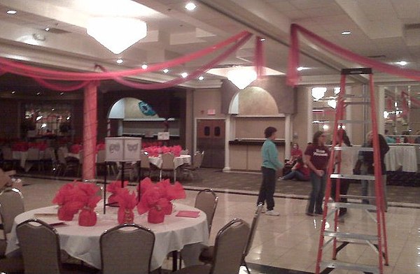 Decorating for prom, students put finishing touches on a ballroom at a banquet hall