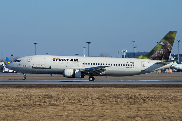 Boeing 737-400 combi aircraft of First Air with passenger windows behind the wing but not ahead