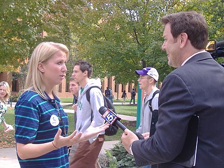 A WTTG reporter conducts an interview on the campus of George Mason University in 2008