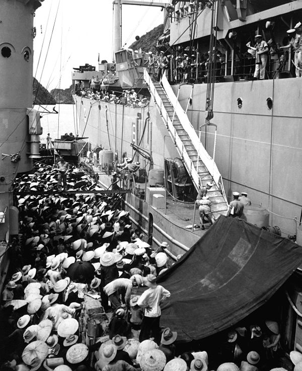 North Vietnamese refugees move from a French landing ship to the USS Montague during Operation Passage to Freedom in August 1954.