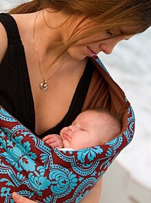 William Sears advises mothers to carry their baby on the body as often as possible. HeavenlyBundlePouch.jpg