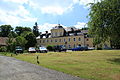 Castle (No. 1), western economic wing (No. 4, 5), stone trough, as well as enclosure wall at the manor park with gate entrance, consisting of pillars and wrought iron gate (individual monuments to ID No. 09303367)