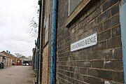 Lewis Howard Avenue Street Sign with the Road in the Background (2018)