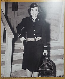 The paymaster of NAS Pasco was a WAVE, here she is seen with a duffel of paychecks and her sidearm. NAS Pasco paymaster.jpg