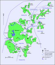 A map of the Orkney archipelago showing main transport routes. A small island with a high elevation is at south west. At centre is the largest island, which also has low hills. Ferry routes spread out from there to the smaller islands in the north.
