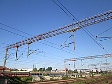 Gantry with old and new suspended equipment at Grivita railway station, Bucharest Overhead catenary bridge.jpg